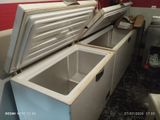 a freezer that is open and sitting in a kitchen
