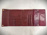 an image of a red leather wallet sitting on top of a white table