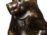 statue of a monkey sitting on its hind legs on a white background