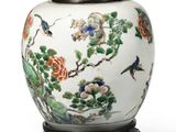 a white vase with flowers and birds painted on it