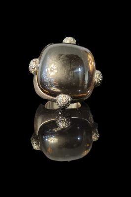 silver plated ring with a large glass stone in the middle of it