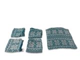 set of four teal and white knitted pillows and a blanket