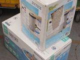 three boxes stacked on top of each other on the street