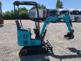 an image of a small excavator in a parking lot