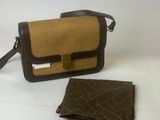 brown and black purse and wallet on white surface