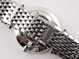 a close up of a watch on a white surface