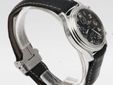 an image of a wrist watch with a black dial and black leather strap