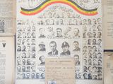 some old papers are on a table with a bunch of pictures on it
