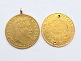 two gold coins, one of which has a head of a woman and the other of which has a crown