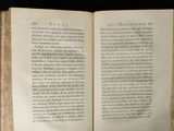 an open book on a table with a black background