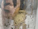 a metal container with a picture of a man on it