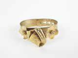 a close up of a gold ring on a white surface