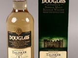 a bottle and box of douglas ' s scotch whisky sitting on a table