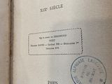 an open book with stamps on it sitting on a table