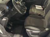 the interior of a car with the door open and the driver ' s seat down