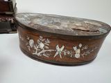 a small wooden box with flowers and birds on it