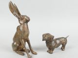 two bronze figurines of a rabbit and a dog