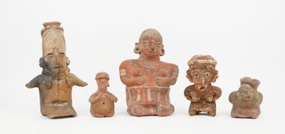 several clay figurines of different shapes and sizes on a white surface