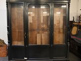 a large black cabinet with glass doors in a room