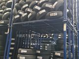 tires stacked on a rack in a warehouse with a lot of them
