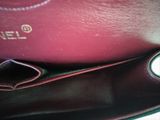 the inside of a red purse with a gold logo on it
