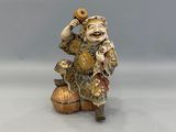 an image of a figurine of a man sitting on top of a ball