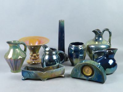 a group of vases and a clock sitting on a table