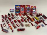 many different types of toy cars and trucks on the table