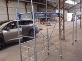 a car that is parked in a building with scaffolding around it