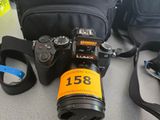 a camera that is sitting on a table next to a bag