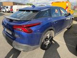a blue car that is parked in a parking lot