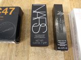two boxes of makeup are sitting on a table next to each other