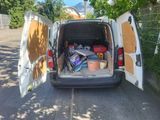 a white van with a bunch of stuff in the back of it