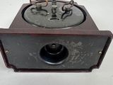 an old radio sitting on top of a wooden table