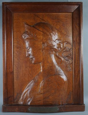 an image of a wooden plaque with a woman ' s head on it