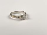 a close up of a diamond ring on a white surface