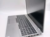 a silver laptop with a black keyboard on a white surface