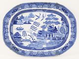 a blue and white plate with a picture of a dragon on it