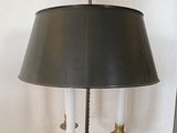 a lamp that is sitting on a table with a lamp shade on it