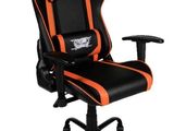 a close up of a gaming chair with an orange and black design