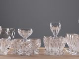 bottles and glasses are lined up on a wooden table
