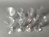 several empty wine glasses are lined up on a table