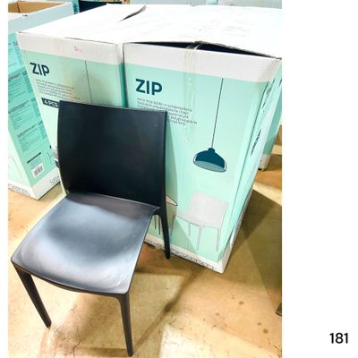 une chaise noire posée devant une pile de cartons
