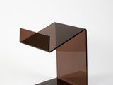 une photo d'une table d'appoint en verre brun avec un piètement noir