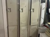 several lockers in a room with a computer on top of them