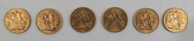 five gold coins are arranged in a row on a white surface