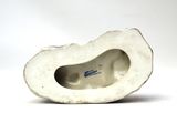 porcelain figurine of a woman ' s foot in a white shell