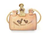 a small wooden bag with a figurine on top of it