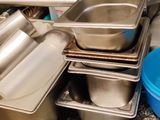 many pans and pans sitting on a counter