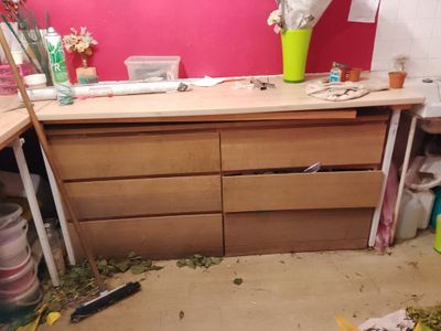 a messy kitchen with a lot of clutter on the counter